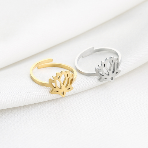 Goudkleurige en zilverkleurige lotusringen op witte stof – verstelbare spirituele sieraden met symbolisch ontwerp.