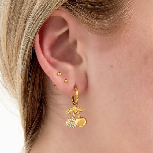 Goudkleurige Cherry Deluxe oorbellen gedragen in oor – stijlvolle sprankelende kersenoorbel van stainless steel