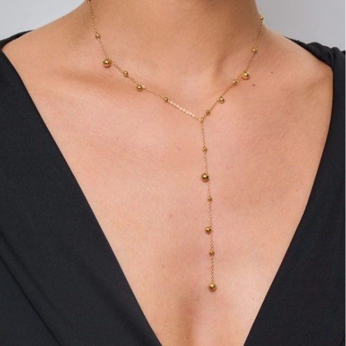 Goudkleurige stainless steel Y-ketting met bolletjes gedragen om de hals