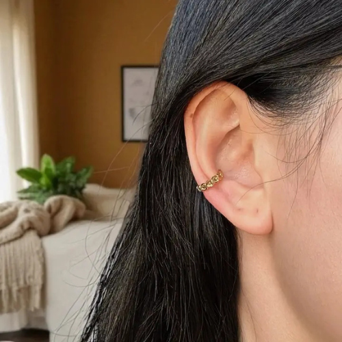 Kleine, subtiele hartjes earcuff van stainless steel gedragen om het oor